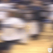a blurry picture of a basketball game with a bulldogs logo on the bottom