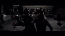 Batman And Catwoman Kicking Ass - The Dark Knight Rises GIF - The Dark Knight Rises Kicking Ass Butt Kicking GIFs