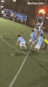 a group of soccer players on a field with a beelup.com logo