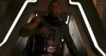a blurry picture of a person standing in a dark room with lights behind them .