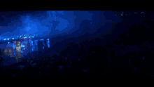 a blurry picture of a person 's hand in front of a blue light