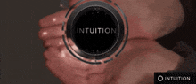 a black circle with the word intuition in the middle