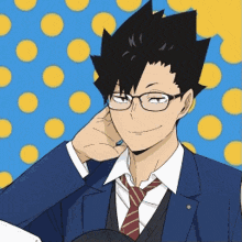 a man wearing glasses and a suit is smiling and holding his hand to his ear