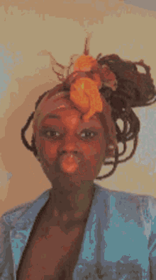 a close up of a woman 's face with a bun in her hair .