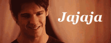 a man smiles in front of a sign that says jajaja