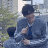 a man in a suit and tie is giving a thumbs up sign