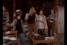 a group of people dancing in a living room