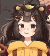 a girl with a leaf on her head is wearing a bear costume .
