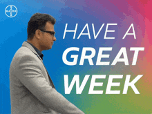 a man in a suit is standing in front of a sign that says " have a great week "