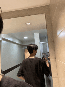 a man is taking a picture of himself in a mirror