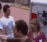 a group of people standing in front of a trailer with the website www.hiddeninthesand.com on the bottom right