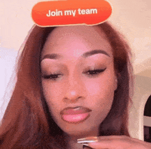 a woman is wearing a red sticker that says join my team