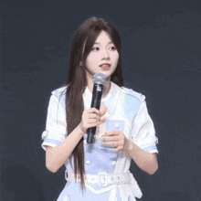 a girl holding a microphone and a cell phone