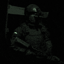 a soldier is holding a gun and wearing a helmet that says ' tactical ' on it