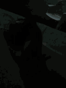 a close up of a person 's leg in the dark with a blue object in the background .