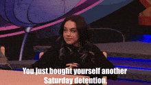 a woman sitting at a table with the words " you just brought yourself another saturday detention "
