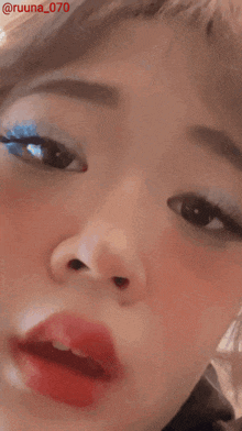 a close up of a woman 's face with the name ruuna_070 on the bottom