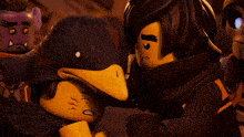 a lego figure with a black duck on its head