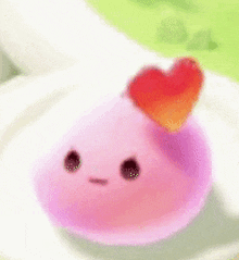 a pink balloon with two hearts on it is sitting on a plate .