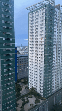 a tall building with a lot of windows is surrounded by other tall buildings