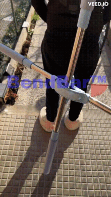 a person standing on a tiled floor with the words veed.jo written on the bottom
