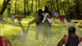 a painting of a group of people fighting in a forest