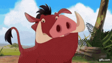 a cartoon pig with large tusks is standing next to a tree in the jungle .
