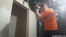 a man wearing boxing gloves is standing in a room with a freegifmaker.me watermark
