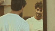 a man looking at his reflection in a mirror with a polo shirt on