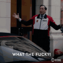 a man standing in front of a car with the words what the fuck written below him