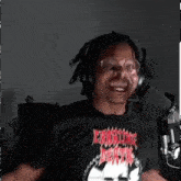 a man wearing headphones and a t-shirt that says ' eternal decay ' on it