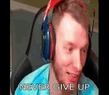 a man wearing headphones is sitting in a chair and says never give up