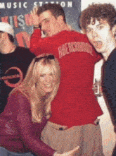 a man wearing a red abercrombie shirt is posing with a woman