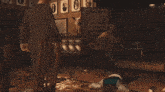 a man is laying on the floor while another man sits on the floor