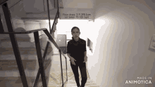 a woman is walking down a set of stairs with a sign that says floor area 319-398 sqm lot area 70-100 sqm