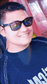 a man wearing sunglasses and a black shirt that says ' ao ' on it