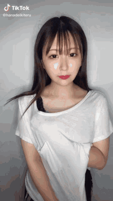 a young woman is wearing a white shirt and a black bra .