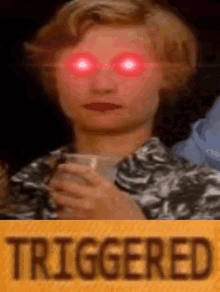 a woman with red eyes is holding a glass of wine and the word triggered is on the yellow background .