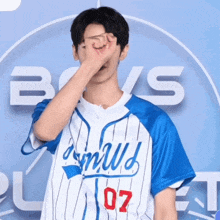 a man wearing a blue and white jersey with the number 07 on it