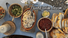 a table with bowls of food and a sign that says tzaheram tovim