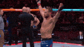 a man in a boxing ring with the word wells fargo on the back