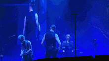 a man playing a guitar and a man playing a keyboard are on stage