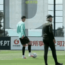 a man kicking a soccer ball in front of a sign that says ' pt '