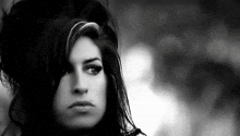 a close up of a woman 's face with a serious look on her face