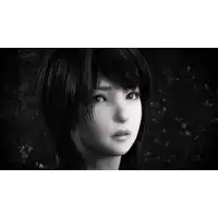 a black and white photo of a girl with short hair looking at the camera