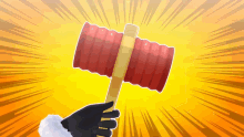 a person is holding a red hammer in their hand