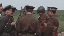 a group of soldiers are gathered in a field and one has the number 10 on his uniform