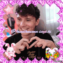 a picture of a man making a heart shape with his hands and the words precious baby angel on the bottom