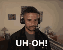 a man wearing headphones and a microphone is making a funny face and saying uh-oh !