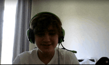a young man wearing green headphones and a microphone